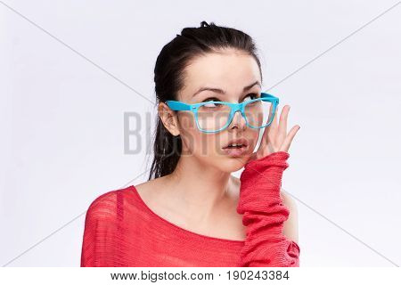 Woman in blue glasses on isolated background, portrait.