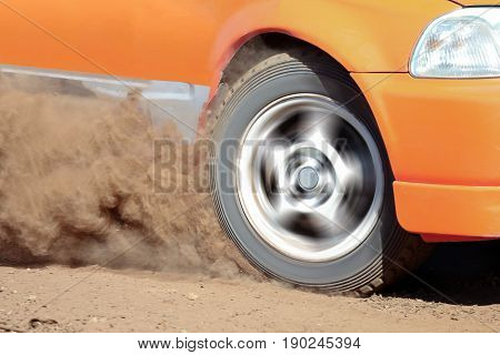 Rally Car turning in dirt track,dust splash