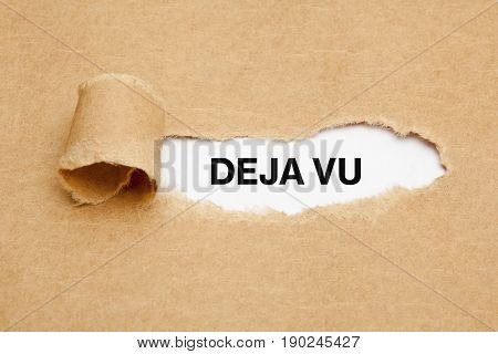 Text Deja Vu appearing behind torn brown paper.