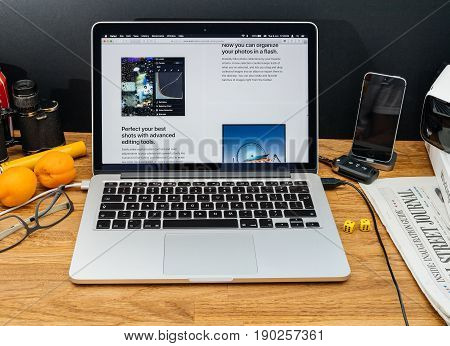 PARIS FRANCE - JUNE 6 2017: Apple Computers website on MacBook Retina in creative environment showcasing latest macOS High Sierra from Apple at WWDC 2017 - new photo app organization files