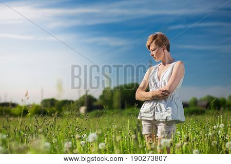 Woman with short dark hair is sad outside