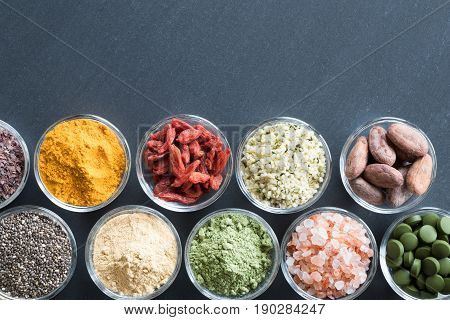 Selection Of Superfoods On A Black Background With Copy Space