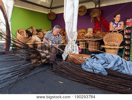 CAMACHA MADEIRA PORTUGAL - SEPTEMBER 10 2016: A basket weaver at work in the factory shop in Camacha Madeira Portugal