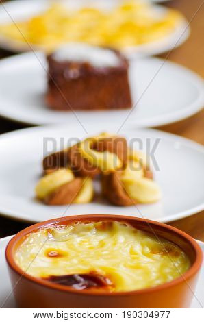Turkish traditional dairy style rice pudding sutlac served in a crock on wood background.