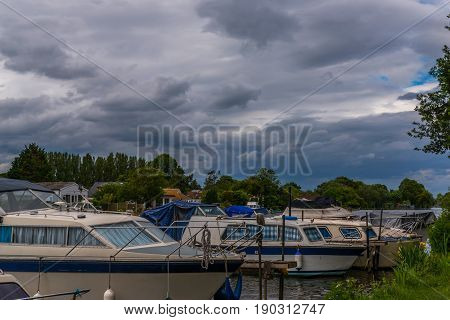 Boats Anchored On The Bank Of The River, Residential Houses On The Other Side, Beautiful Broad River