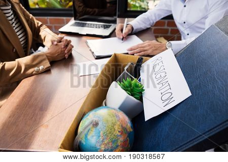 Businessman Resignation Packing Up All Her Personal Belongings And Files Into A Brown Cardboard Box.