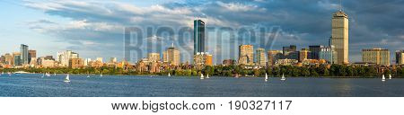 Boston Massachusettes Back Bay Distric with dark clouds behind and sailboats on the Charles River