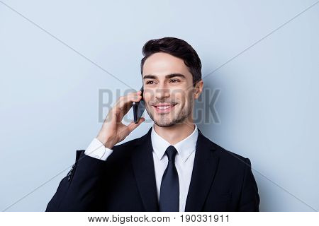 Successful And Happy Young Brunete Entrepreneur Banker Is Having His Phone Nagotiations. He Is In A