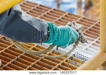 Painted rustcorrosion with Spray Gun on production platform Energy and petroleum industry sea offshore