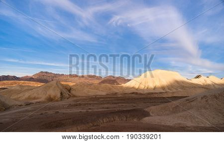 national; desert; park; death; valley; landscape; sky; california; sand; mountains; nature; southwest; travel; rock; geological; scenic; badlands; dunes; wild; cracked; tourism; natural; canyon; horizon; american; west; western; famous; sandstone; skyline