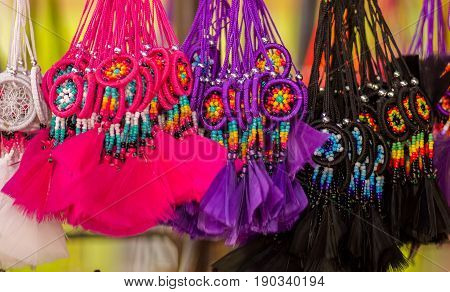 OTAVALO, ECUADOR - MAY 17, 2017: Close up of a small catchdreamer, in colorful market background.