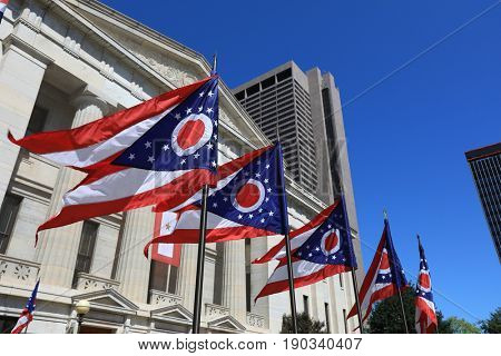 State of Ohio flags waving in front of the Statehouse in Columbus, OH