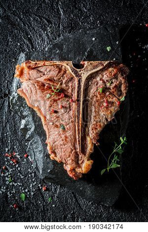 Closeup Of Tbone Steak With Herbs And Pepper