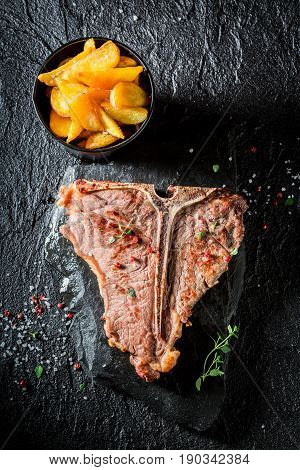 Fresh Chips And Tbone Steak On Black Table