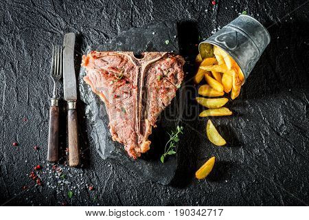 Delicious Chips And Tbone Steak On Black Table