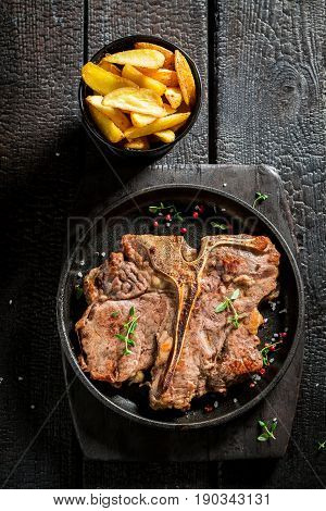 Tasty Chips And Tbone Steak On The Burnt Table