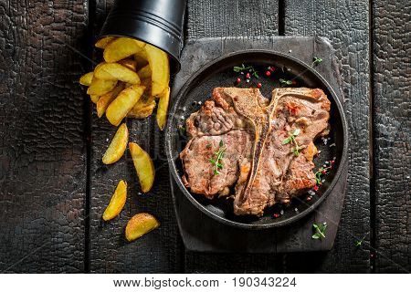 Yummy Tbone Steak And Chips On The Burnt Table