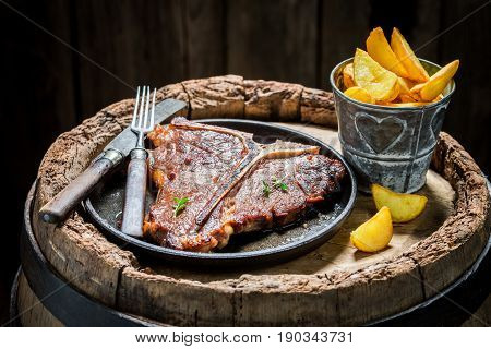 Tasty Chips And Tbone Steak On Old Barrel