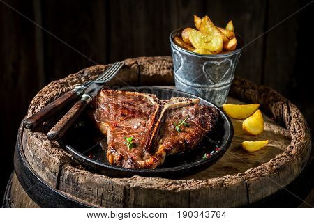 Chips And Tbone Steak On Old Barrel