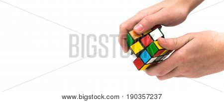 Estonia, Tallinn, May 30, 2017. Rubik's cube in hand on white background