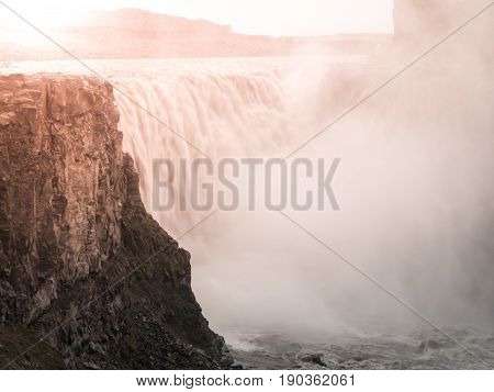 Detifoss waterfall illuminated by sunset, northern Iceland.