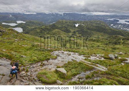 Norwegian landscape with hikers. Ulriken mountain. Bergen surroundings area. Norway