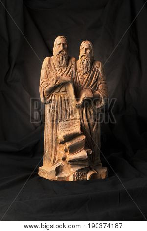 Slavonic Educators Cyril And Methodius Clay Statues Close Up Image. Old Men Hold Scroll Of Holy Scri