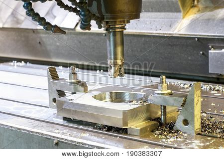 Square industrial metal mold/blank milling. Metalworking mechanical engineering lathe milling and drilling technology. Indoors horizontal image.