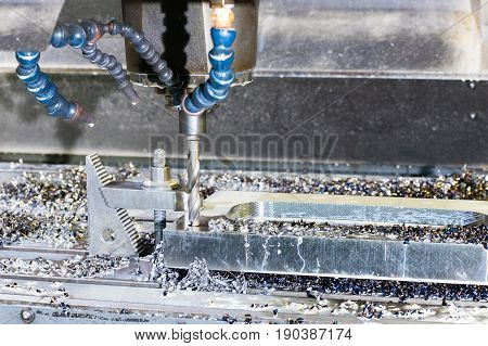 Industrial metal mold/blank speed drilling. Metalworking mechanical engineering lathe and milling technology. Indoors horizontal image.