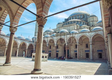 Exterior view of Suleymaniye Mosque through arches in its courtyard in Istanbul Turkey. The mosque was constructed by Sinan for sultan Suleyman the Magnificent