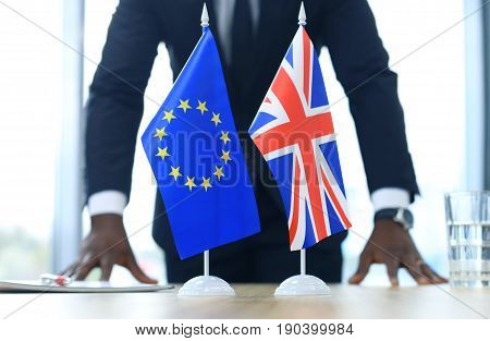 British flag and flag of European Union with businessman near by. Brexit