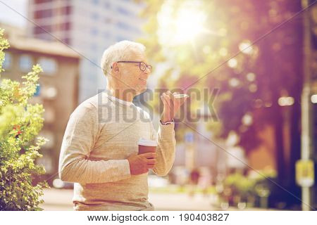 technology, senior people, lifestyle and communication concept - happy old man using voice command recorder or calling on smartphone outdoors