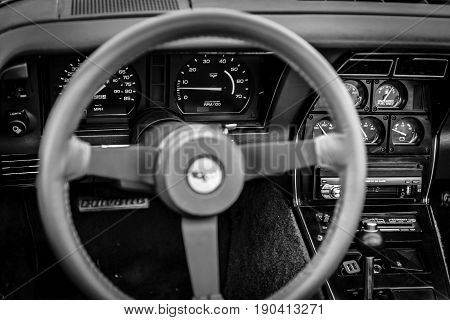 PAAREN IM GLIEN GERMANY - JUNE 03 2017: Interior of the sports car Chevrolet Corvette (C3) 1982. Black and white. Focus on the background. Exhibition 