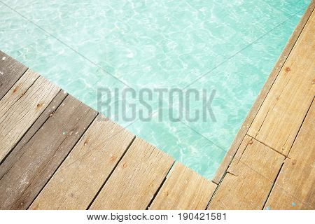 Close up wooden jetty with crystal clear and turquoise sea water of the tropical sea . Top angle view .Rawa island Malaysia .