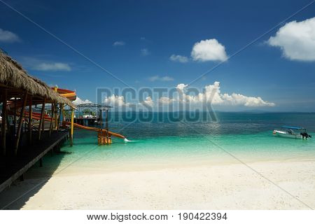 Beautiful tropical beach with waterslide playground on jetty .Rawa island Malaysia .