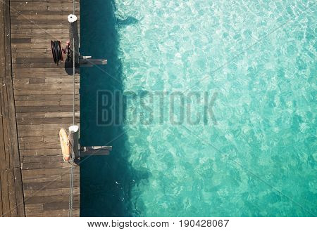 Wooden jetty with crystal clear and turquoise sea water of the tropical sea . Aerial top view .Rawa island Malaysia .