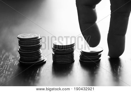 silhouette of hand walkin on stacked of money coins concept in growth in business step by step
