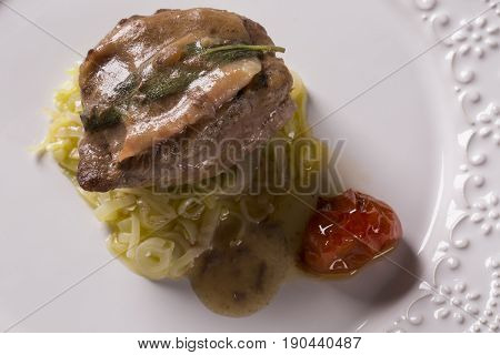 Saltimbocca Veals In Rich Neapolitan Sauce And Tagliatelle Pasta