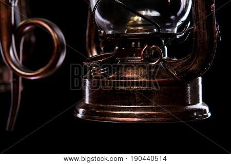 antique bronze iron-shod chandelier isolated on black background. Large chandelier for the living room interior, close-up