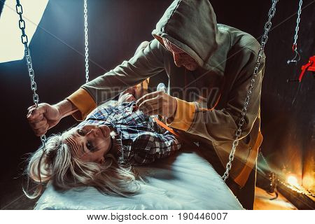 Maniac Is Feeding His Tied Victim With The Cockroach In The Dark Room.