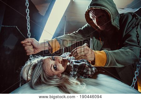 Maniac Is Feeding His Tied Victim With The Cockroach In The Dark Room.