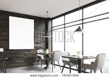 Dark wooden cafe interior with square tables white chairs standing along a panoramic window and a framed vertical poster on a wall. 3d rendering mock up