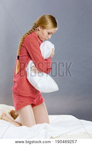 Sad Depressed Girl In Bed Gripping Pillow