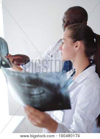 Doctors analyzing an x-ray in a meting. Doctors