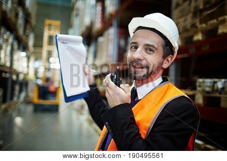 Happy worker of storeage house with walkie-talkie