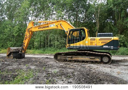 Almere Poort, Flevoland, The Netherlands - June 10, 2017: Yellow Hyundai Robex 300 lc 9 Crawler Excavator on a construction site in the city of Almere. Nobody in the Excavator.