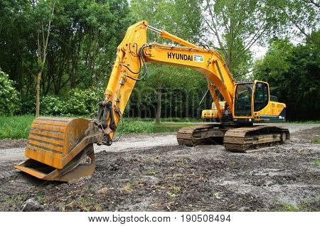 Almere Poort, Flevoland, The Netherlands - June 10, 2017: Yellow Hyundai Robex 300 lc 9 Crawler Excavator on a construction site in the city of Almere. Nobody in the Excavator.