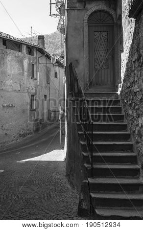 Asso (Como Lombardy Italy): typical street in the historic town. Black and white
