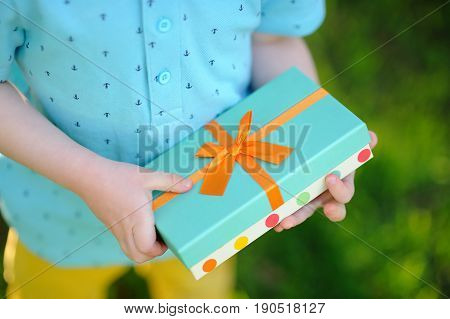 Close-up Of Nicely Wrapped Birthday Gift Being Held By A Child