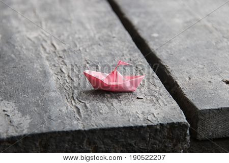 paper boat on old wooden table, journeyconcept